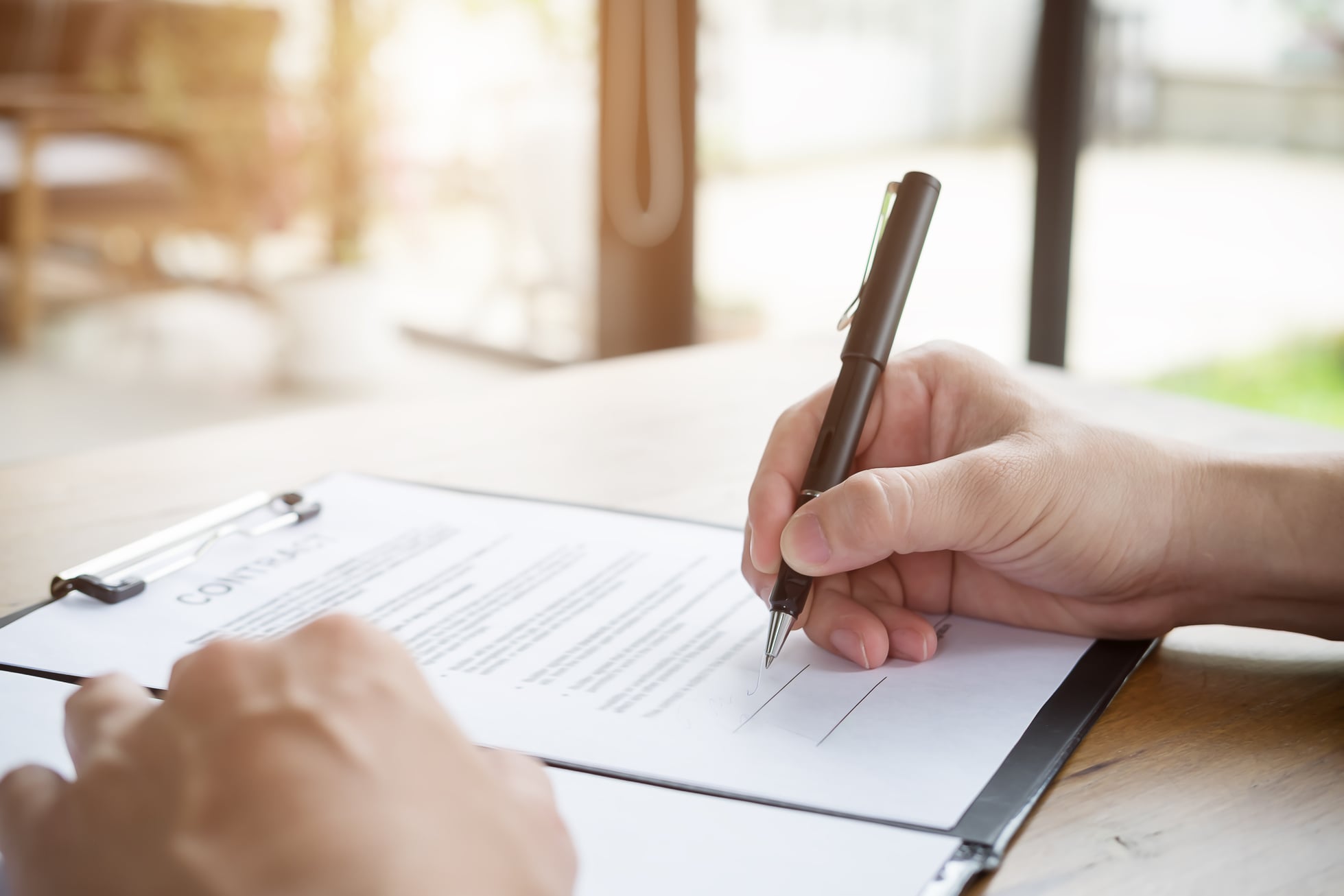 Close Up of Person Signing Contract